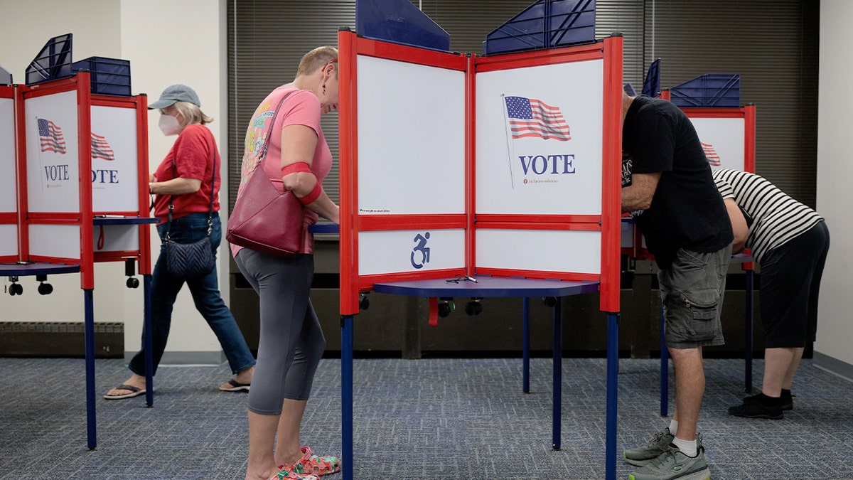 Residents participate in the start of early voting at a Henrico polling site ahead of Virginia’s statewide elections.