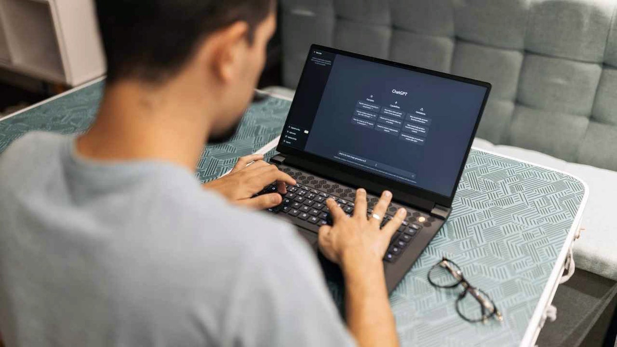 A man uses ChatGPT on his laptop.