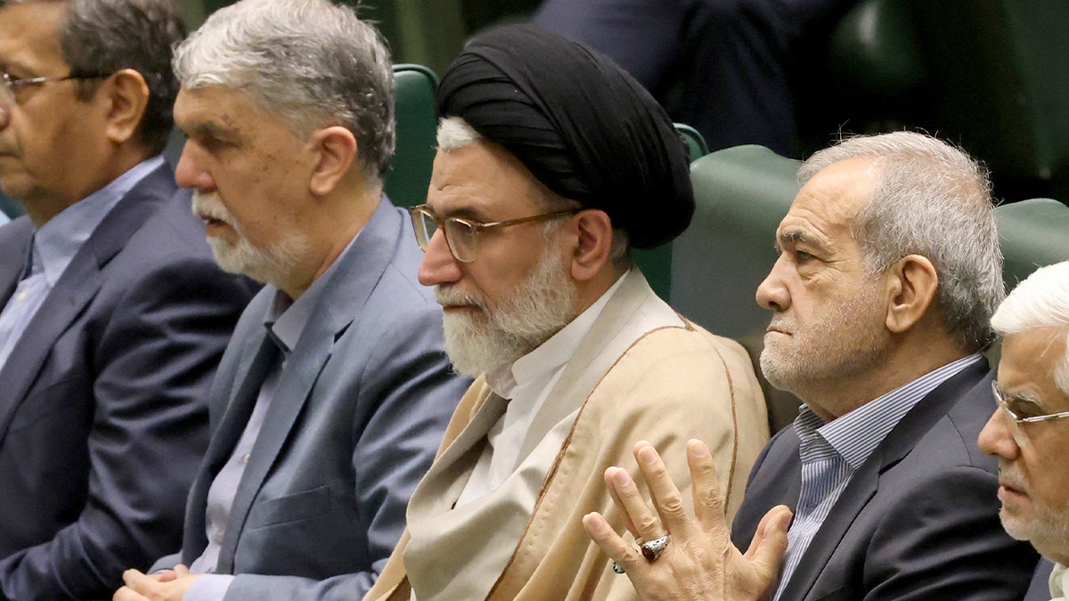 Iran’s Intelligence Minister Esmaeil Khatib sits beside President Masoud Pezeshkian ahead of a parliamentary address in Tehran.