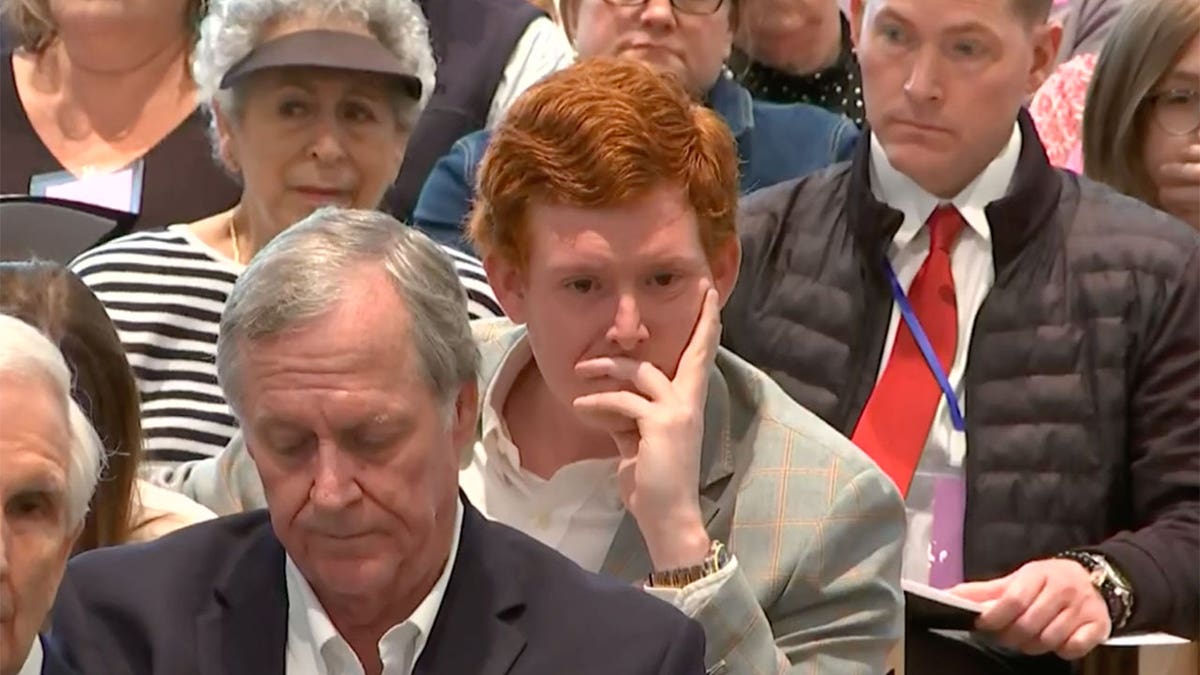 Buster Murdaugh covers part of his face