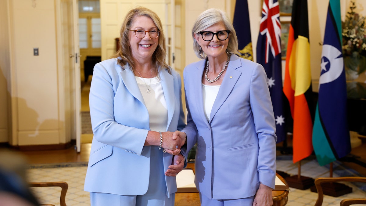 Catherine King and Sam Mostyn greet each other during an official government ceremony at Government House in Canberra.