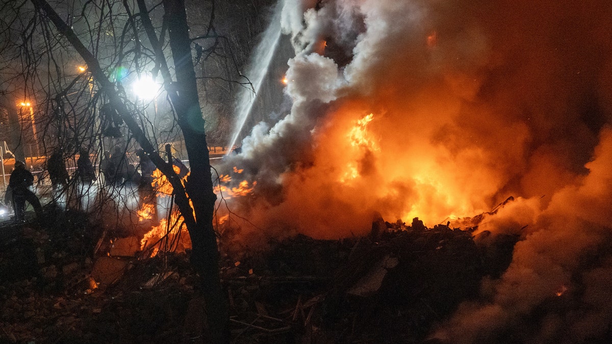 firefighters put out fire after Russian missile struck an apartment building