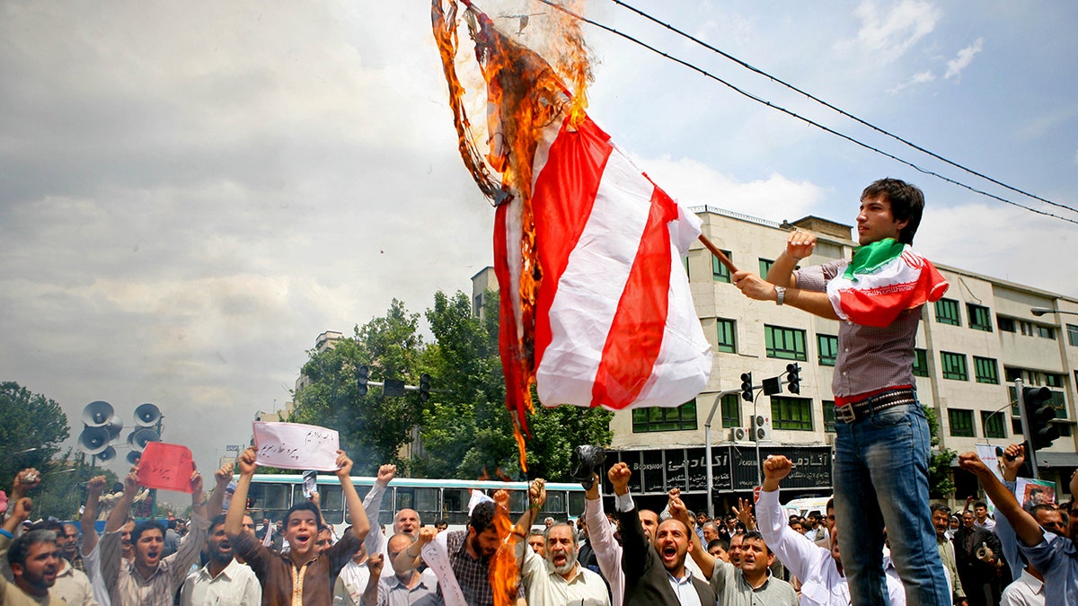 Iranian protester burns U.S. flag