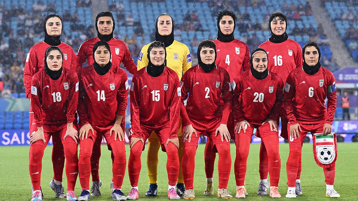 Iranian soccer players pose for a photo