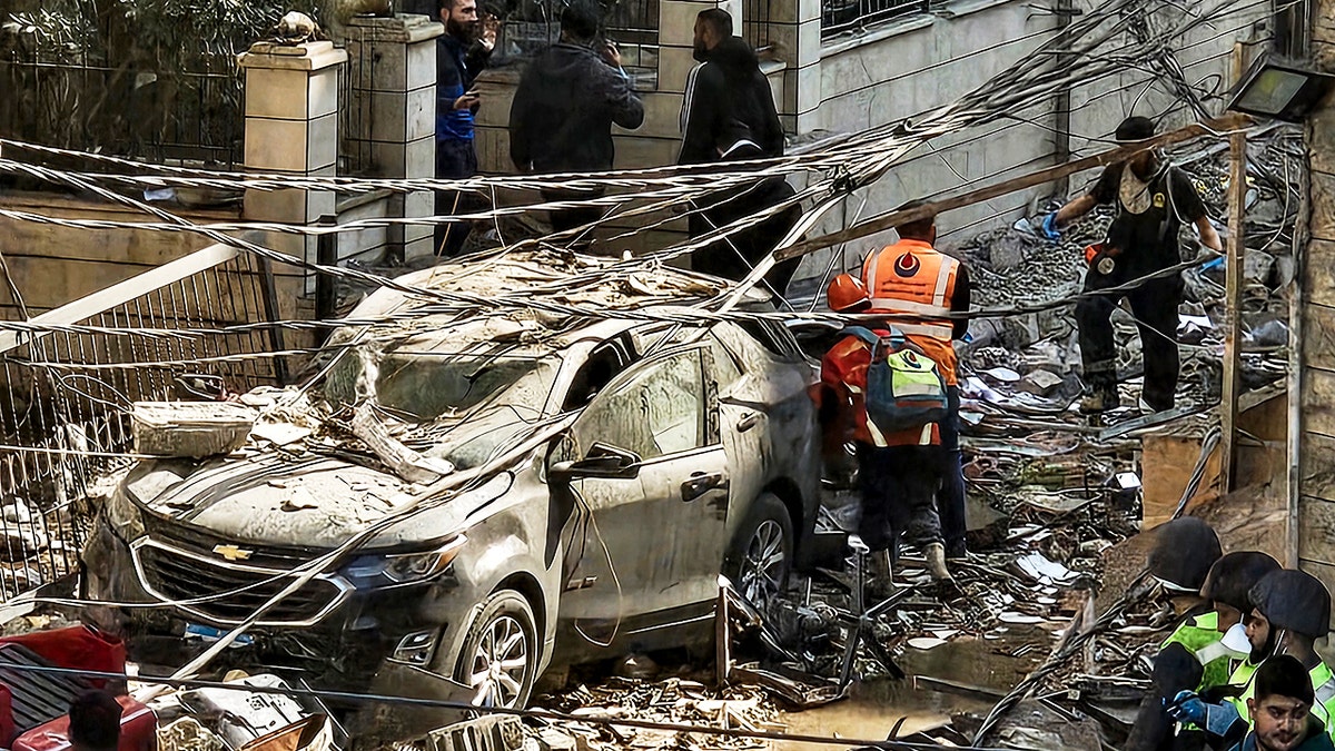 People inspect damage from Israeli airstrike in Beirut, Lebanon