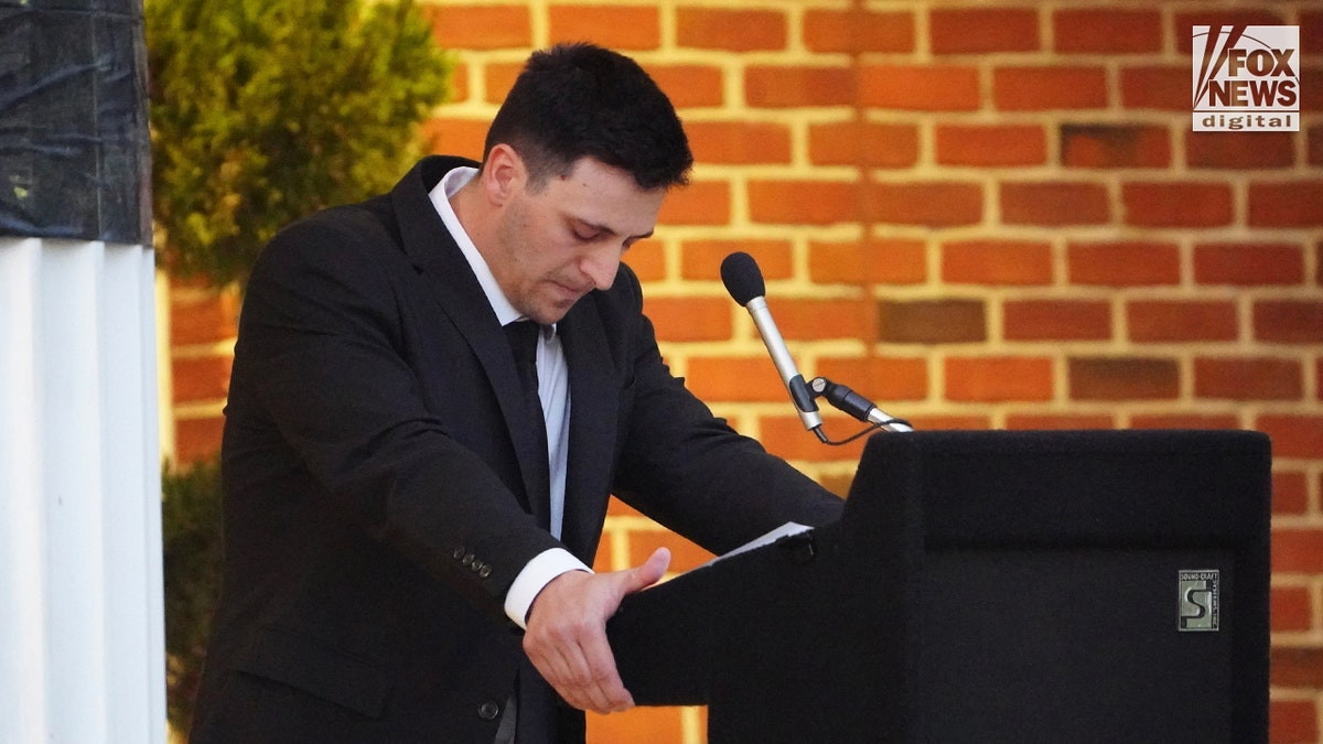 Mourners at a memorial vigil for Jimmy Gracey standing together