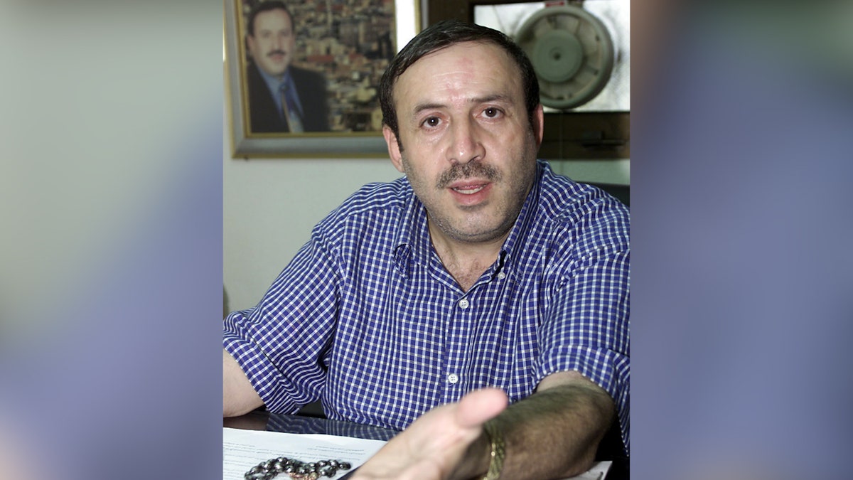 Syrian opposition lawmaker Mamoun al-Homsi sits in his office in Damascus during a 2001 file photo.