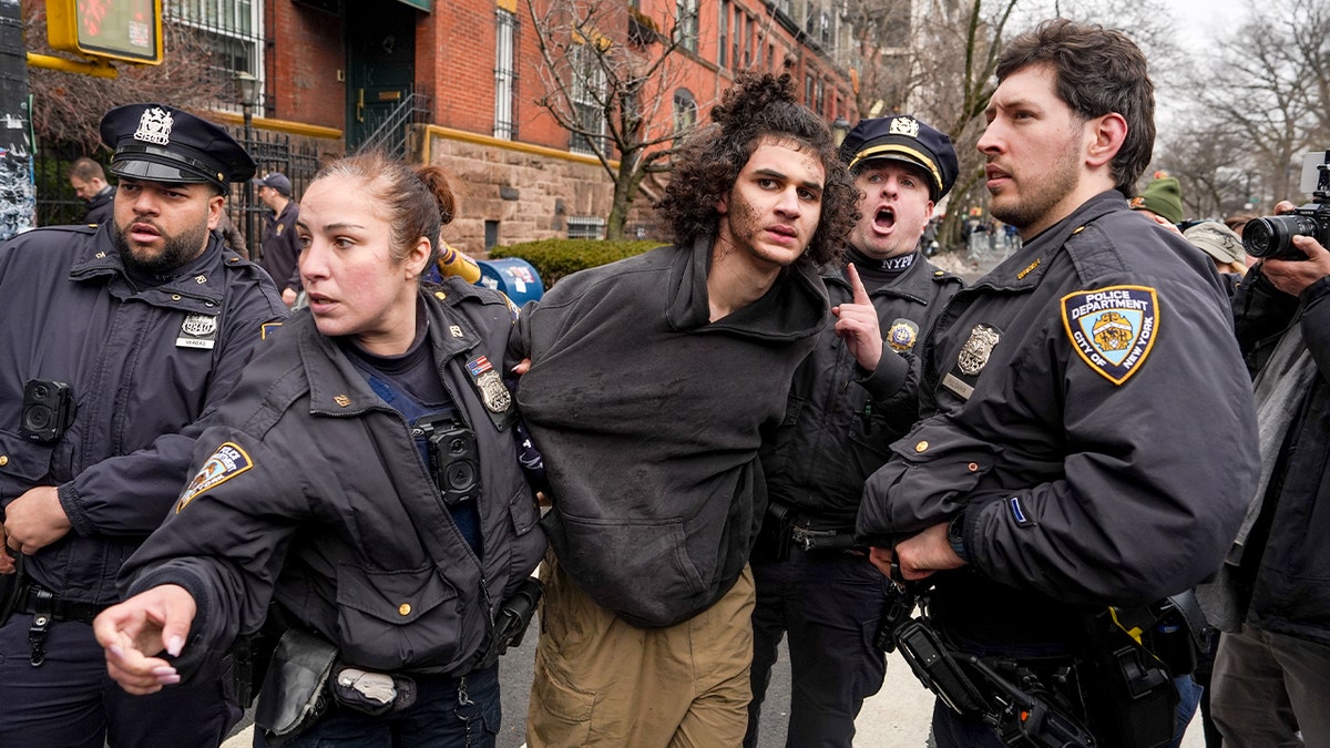 Police detain a man on a New York City street after he allegedly threw an explosive device during a protest.