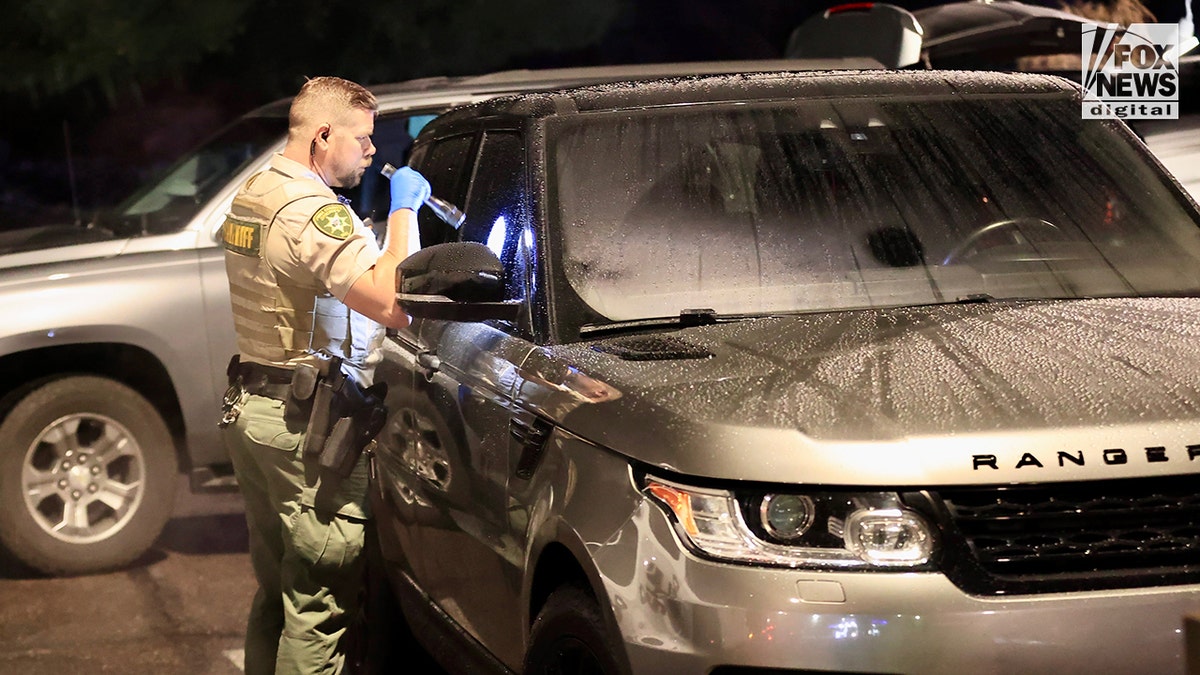 FBI agents inspect a Range Rover following a traffic stop related to Nancy Guthrie's disappearance