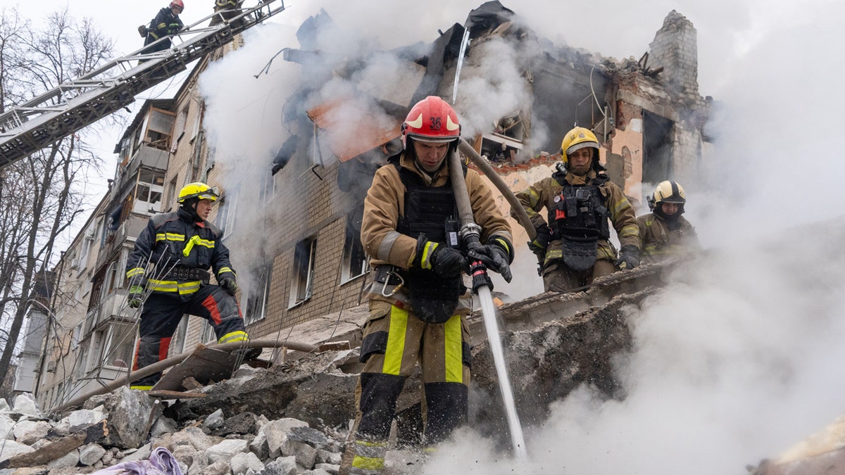 Firefighters respond after a Russian ballistic missile strike on a residential building in Kharkiv, Ukraine