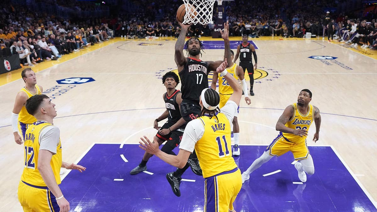 A Houston Rockets player attempts an layup