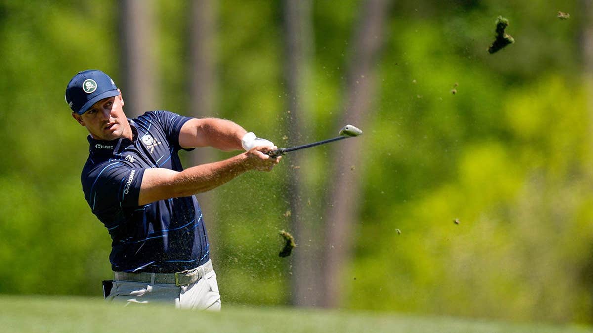 Bryson DeChambeau hitting a tee shot on the 12th hole at Augusta National Golf Club