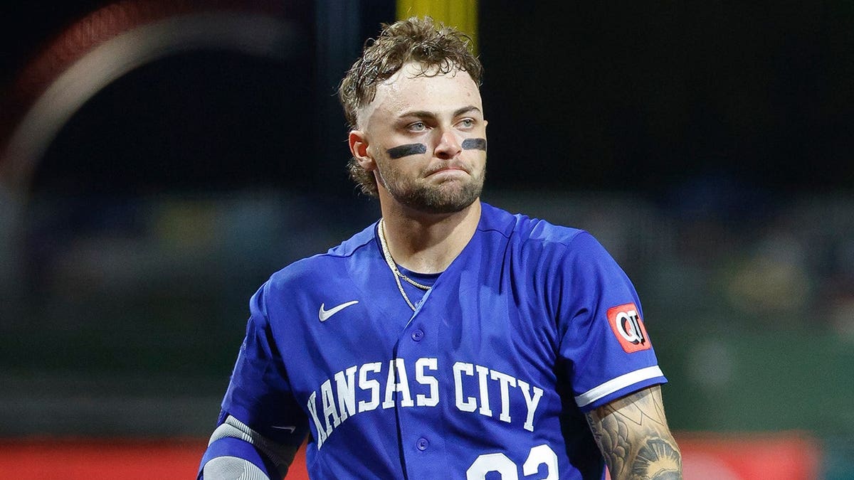 Carter Jensen walking to the on deck circle during a baseball game.