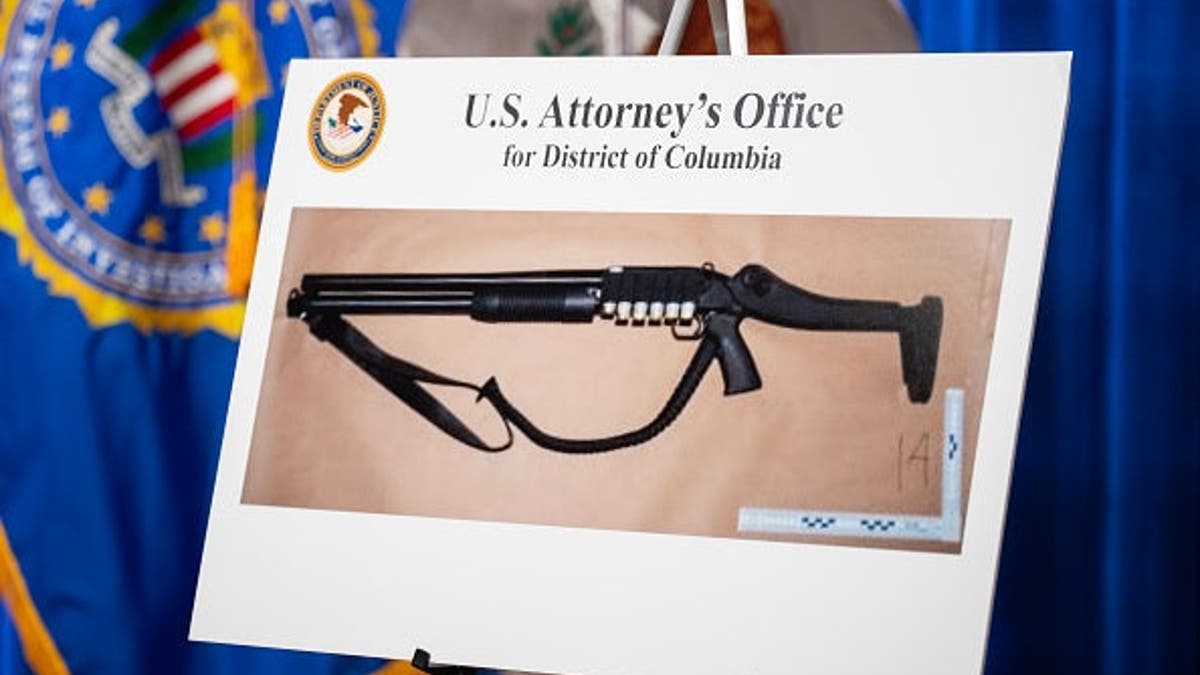 Shotgun used by Cole Tomas Allen displayed on a table at the Department of Justice