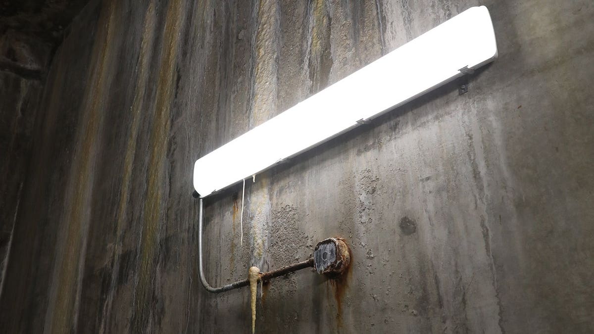 Electrical vault room showing extreme water damage with wet surfaces and debris