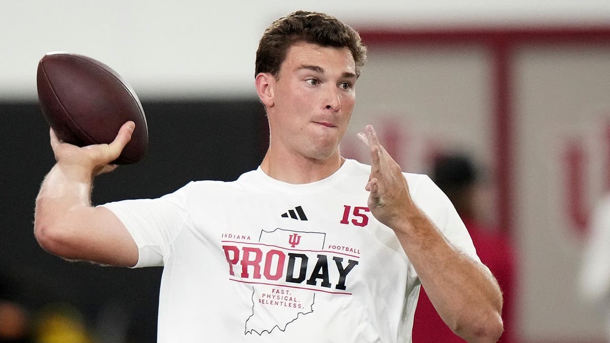 Indiana quarterback Fernando Mendoza looks to throw a pass during pro day.