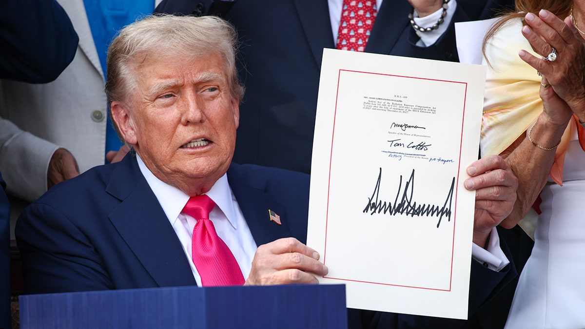 President Donald Trump signing the One, Big Beautiful Bill Act on the South Lawn of the White House with Republican lawmakers present