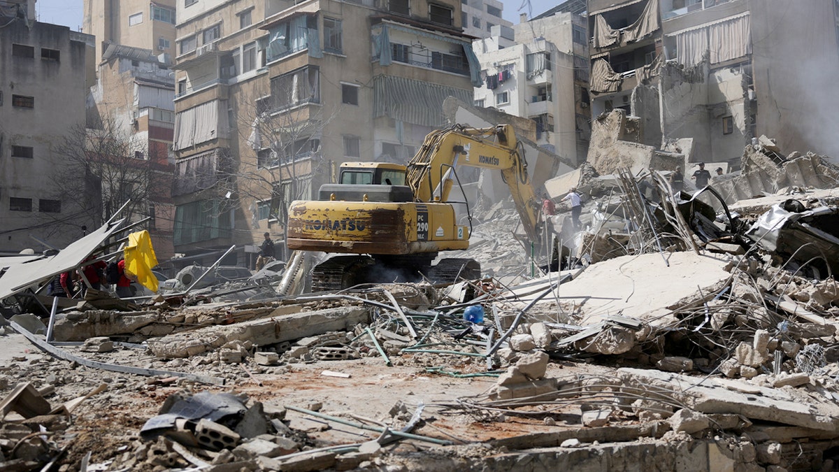 An excavator clearing debris at a strike site in the Zuqaq al-Blat district of Beirut Lebanon