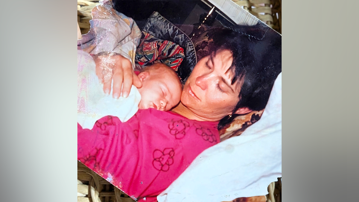 Janice Randle holding a sleeping baby in family photo before her 1992 death in Washington cold case