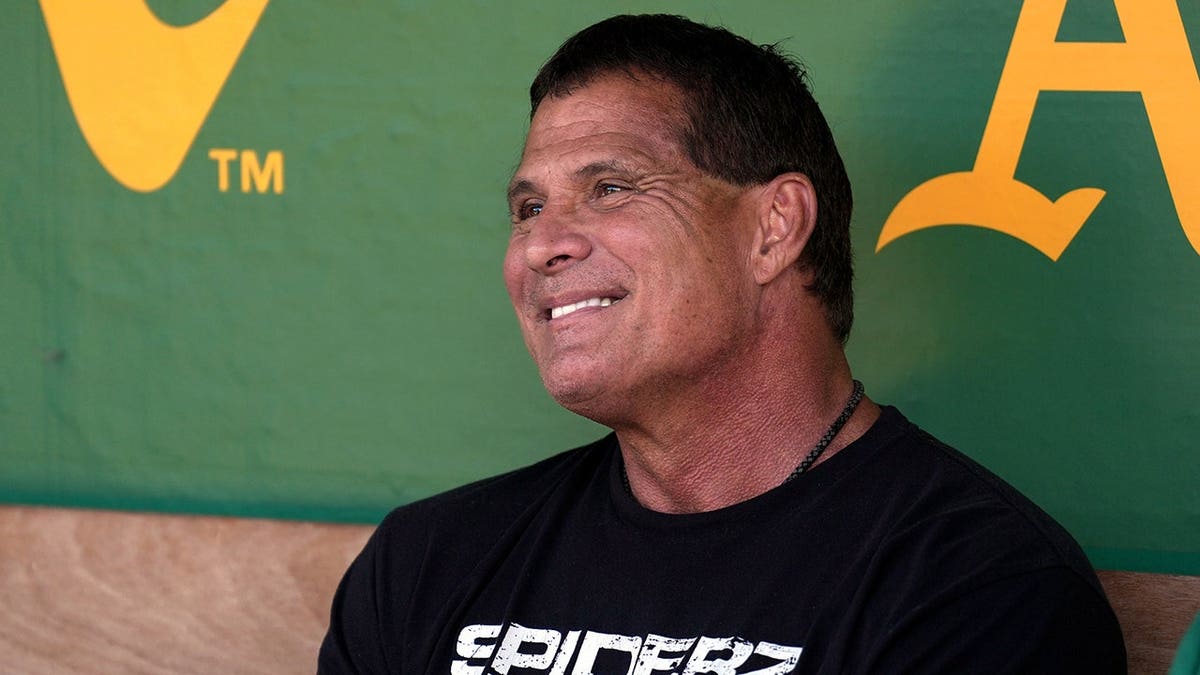 Jose Canseco sitting in the dugout at Oakland-Alameda County Coliseum.
