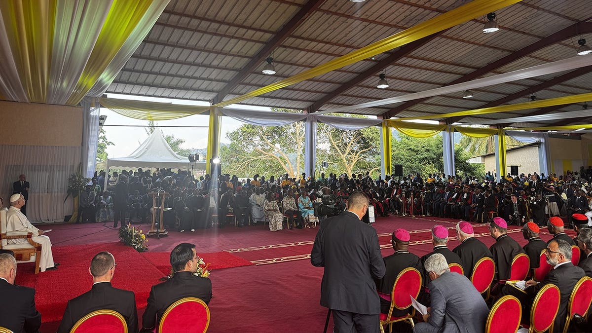 pope leo sits in front of large university gathering