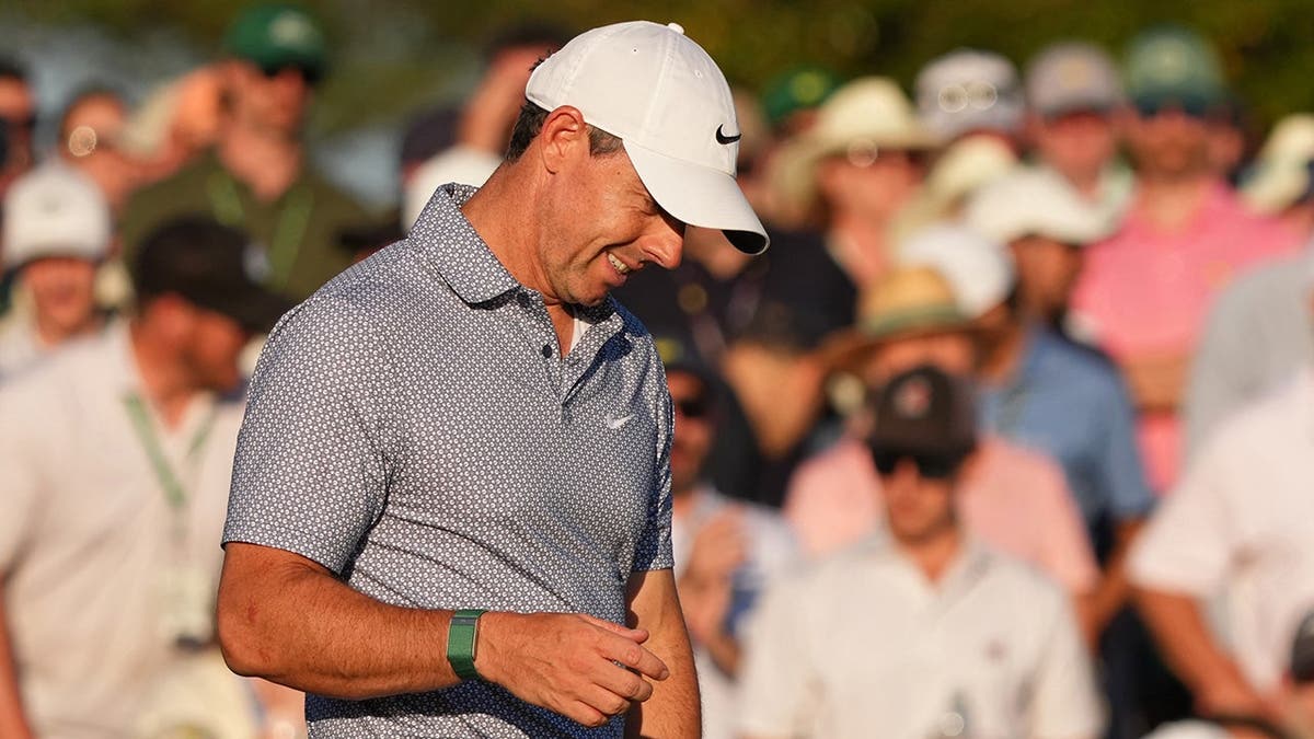 Rory McIlroy reacting after a putt on the 18th green at Augusta National Golf Club