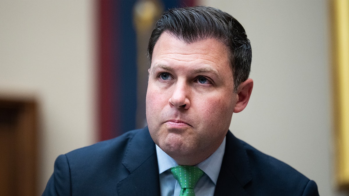 Rep. Ryan Mackenzie sitting at a desk in a committee hearing room