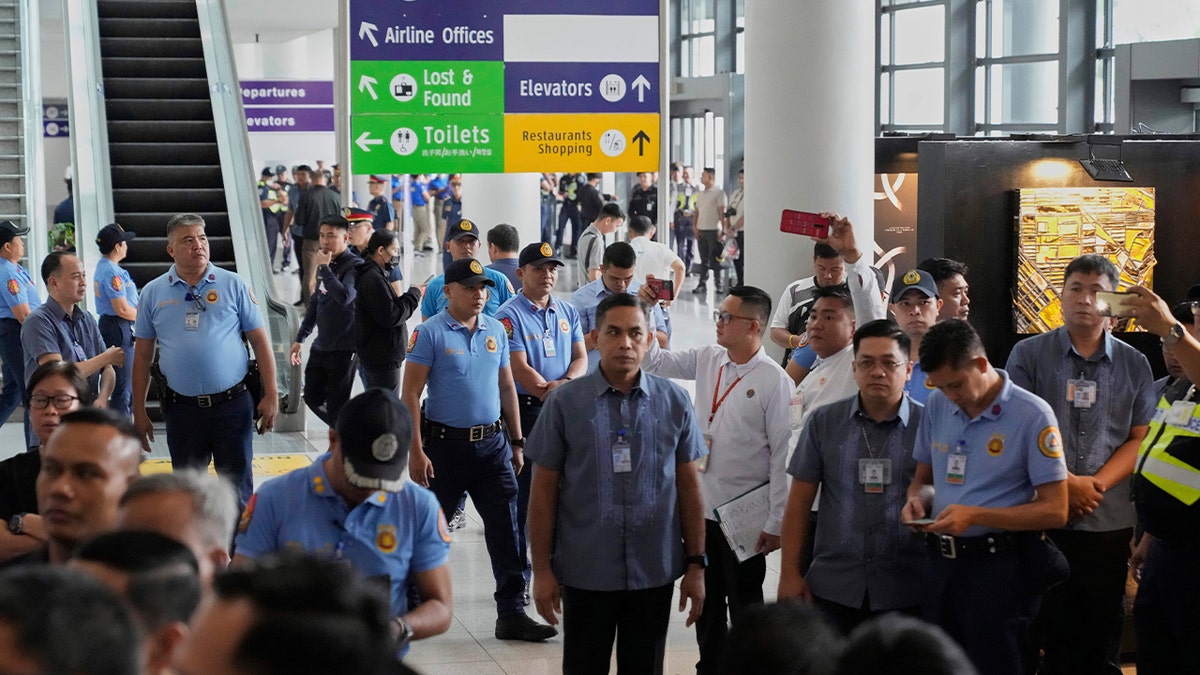 Security officers patrolling airport in Manila after former President Rodrigo Duterte's arrest
