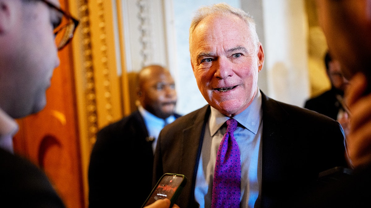 Sen. Tim Kaine speaking to reporters while walking into the Senate Chamber in Washington, D.C.