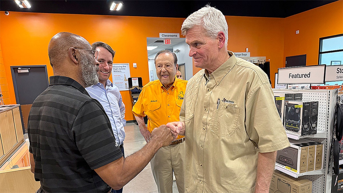 Sen. Bill Cassidy fist bumps a supporter at a gun retailer and firing range in Baton Rouge
