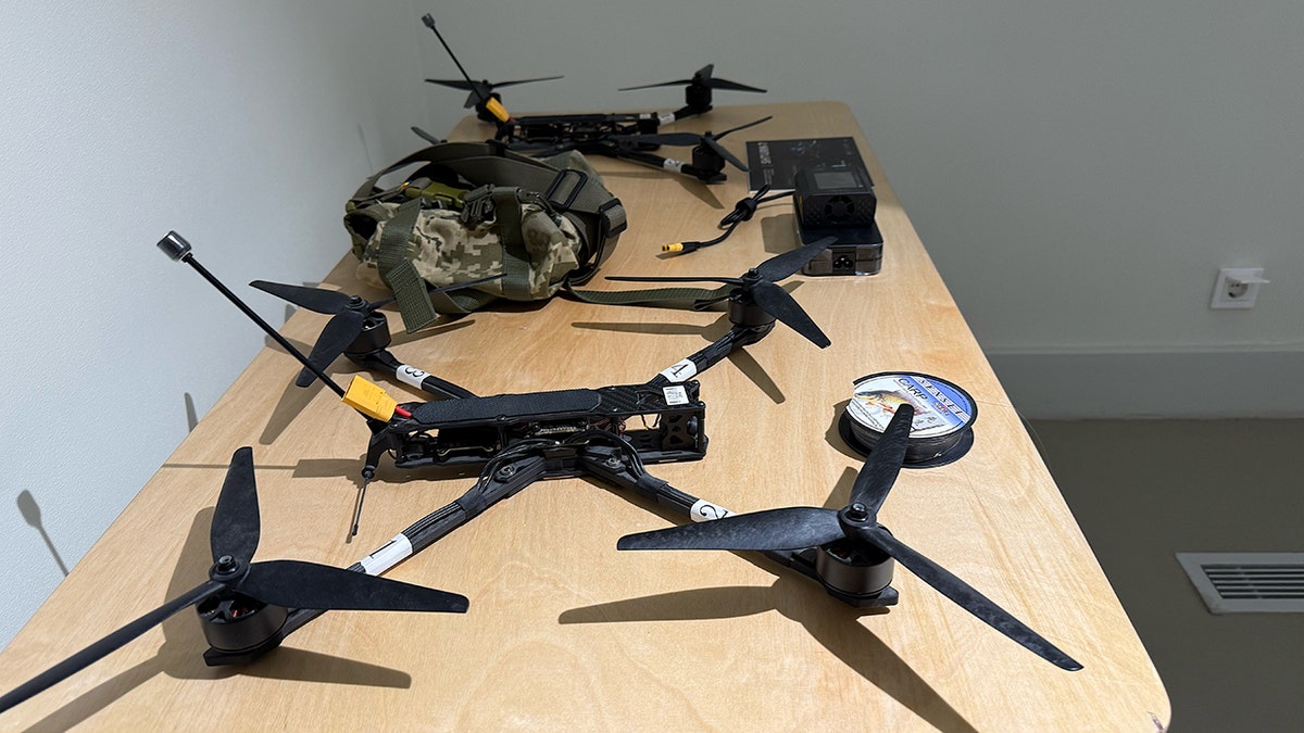 Ukrainian-made drones displayed on tables at a military technology exhibition