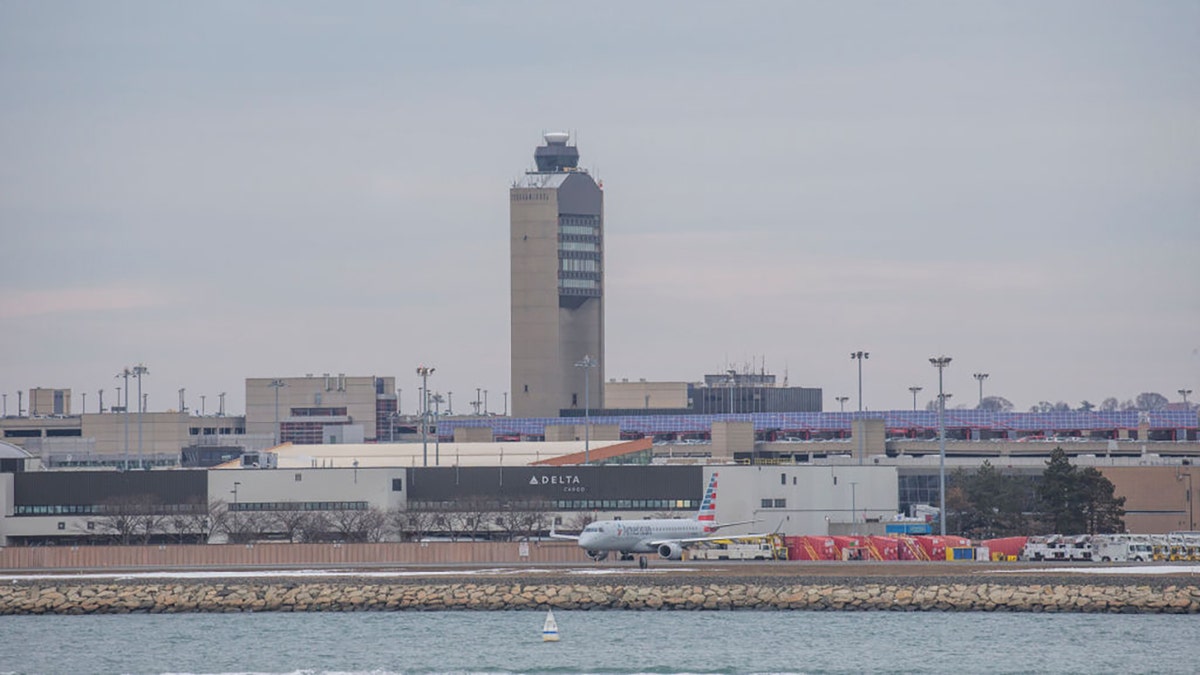 Air traffic control tower and planes at Boston Logan Airport