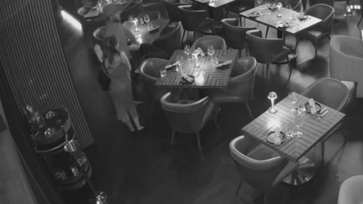 Man and woman seen stealing bottle of cognac