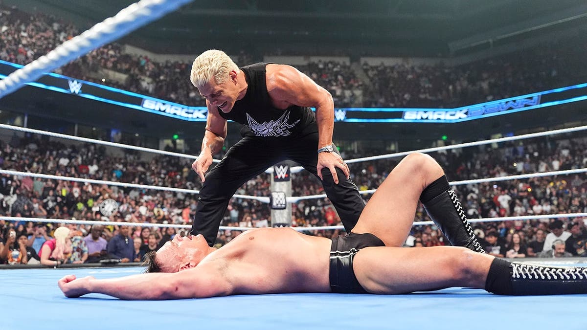 Cody Rhodes standing over Gunther in a wrestling ring at SmackDown