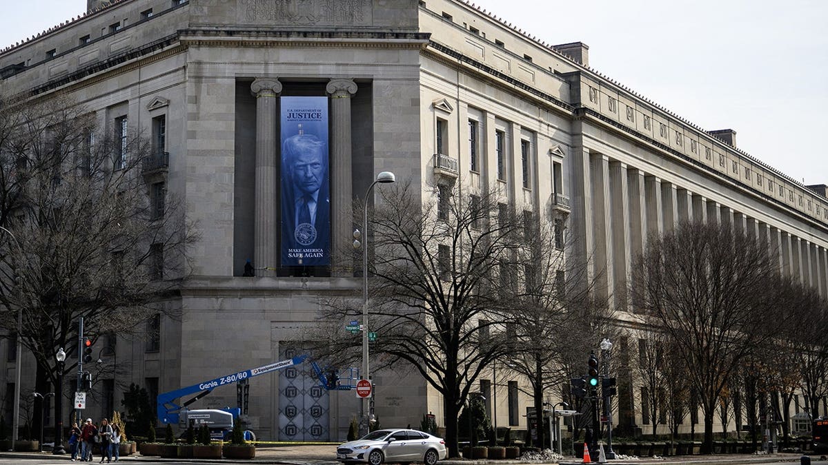 A banner featuring US President Donald Trump displayed on the US Department of Justice building facade in Washington, D.C.