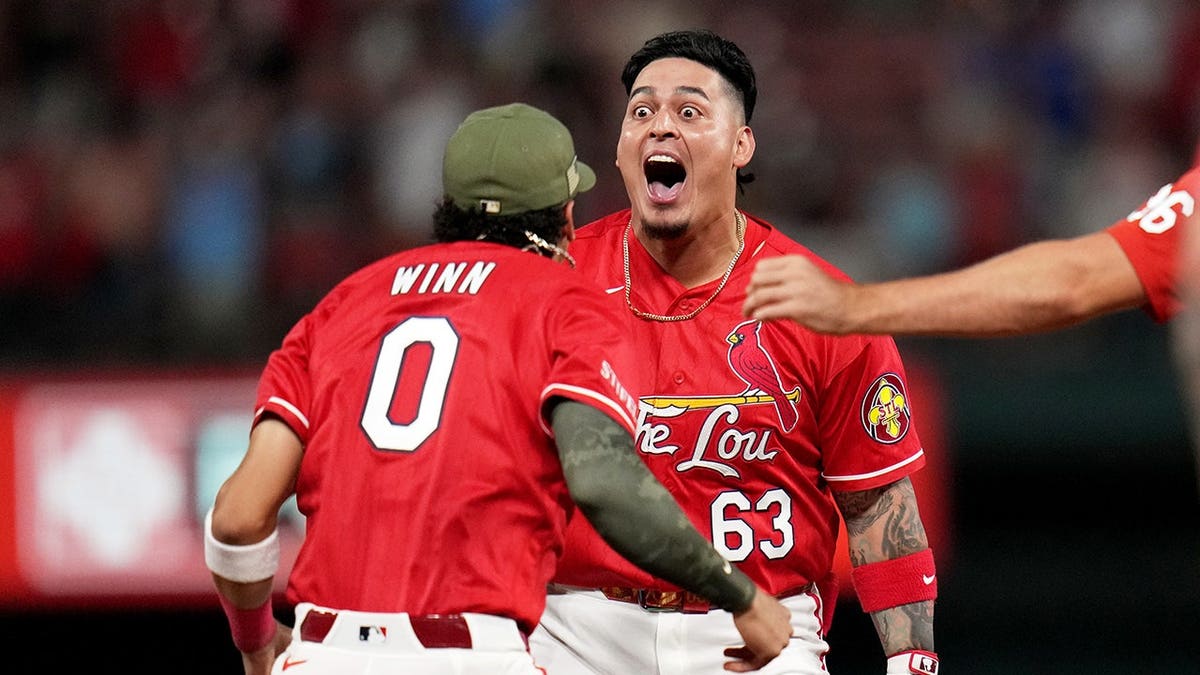 St. Louis Cardinals' Yohel Pozo celebrating with Masyn Winn after a walk-off single in a baseball game