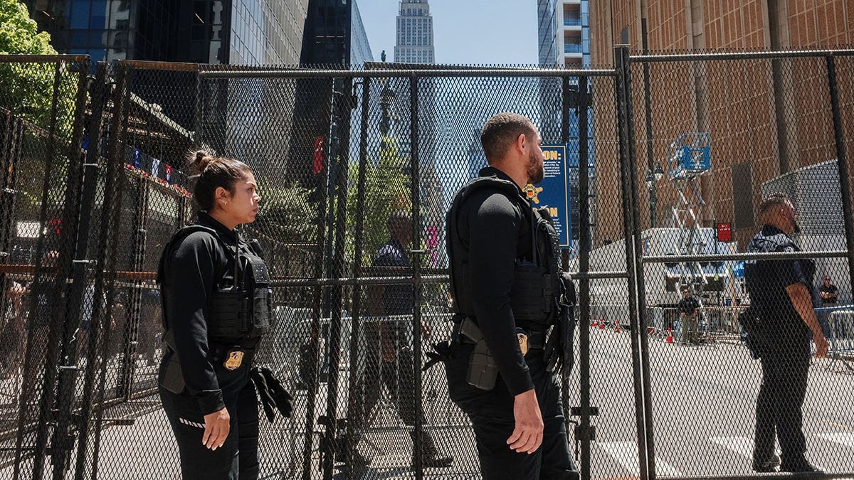 Members of the U.S. Secret Service walking outside Madison Square Garden security fence