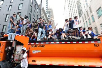 Knicks fans climb on police cars, sanitation trucks as countless others unable to get into jam-packed parade