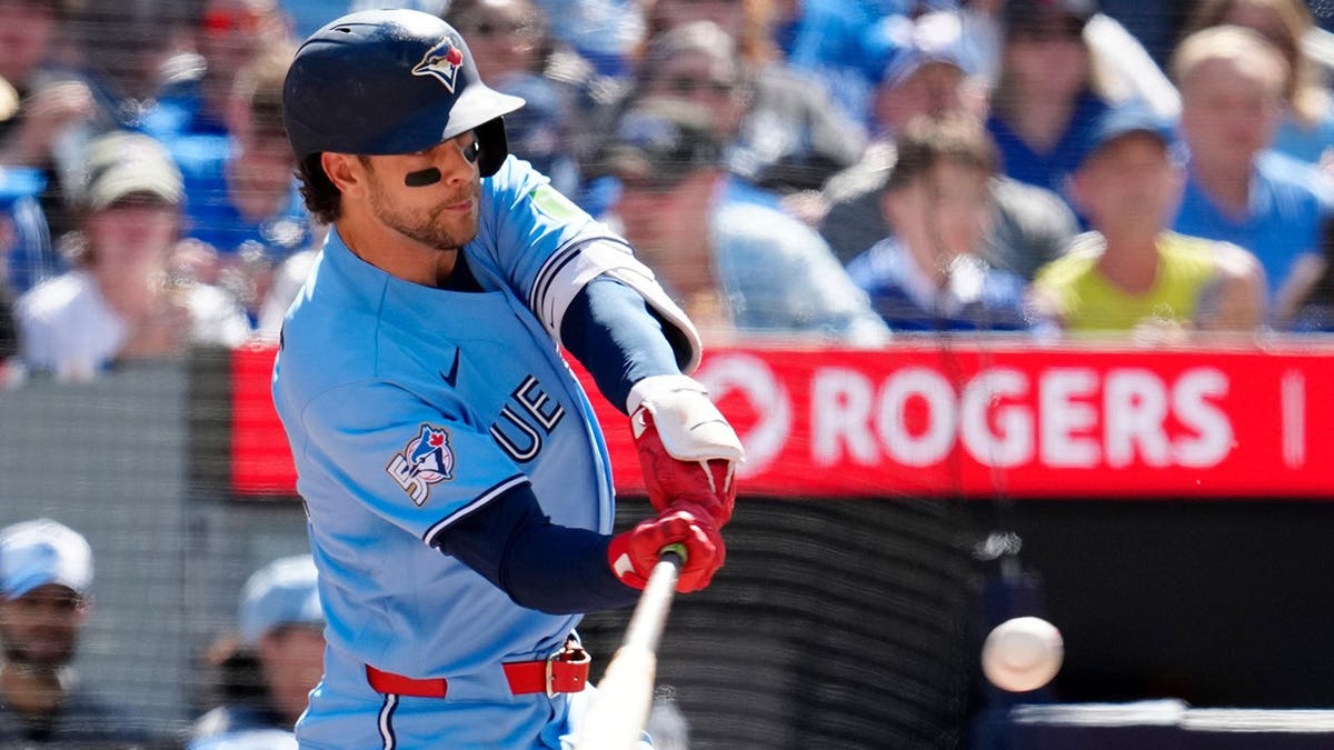 Toronto Blue Jays' Ernie Clement hitting a baseball during a game.