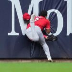 Reds’ Dane Myers carted off field after crashing into wall making acrobatic catch vs Brewers