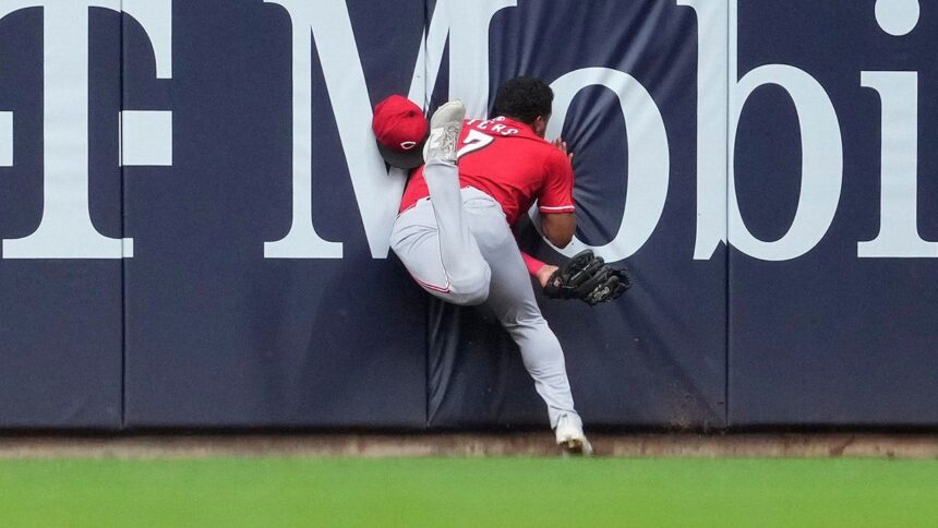 Reds’ Dane Myers carted off field after crashing into wall making acrobatic catch vs Brewers