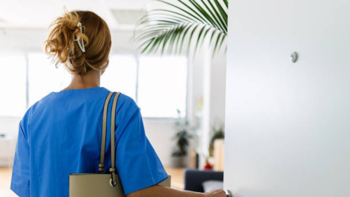 A stock image of a nurse in blue scrubs
