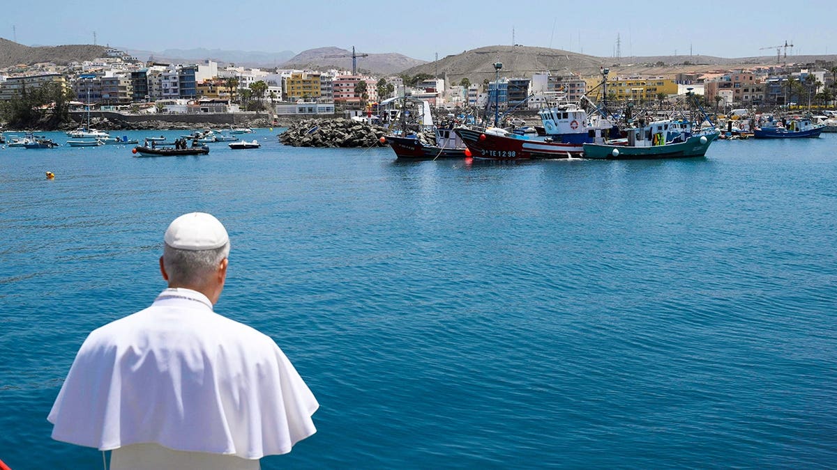 Pope Leo XIV makes a floral offering to migrants lost at sea at the dock of the Port of Arguineguin in Gran Canaria, Spain.