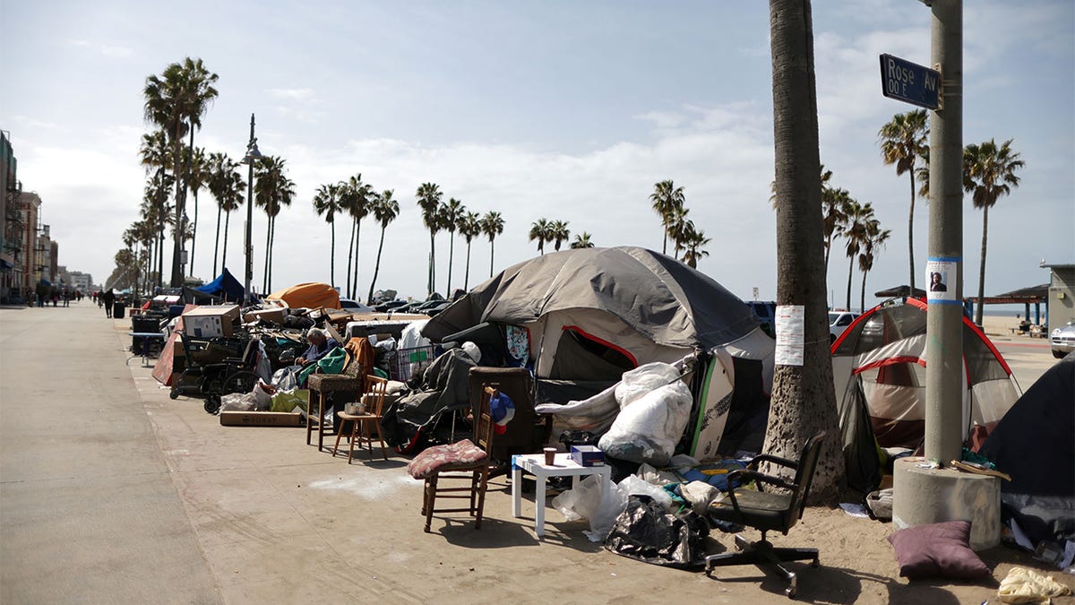 Homeless encampments lining the boardwalk at Venice Beach in Los Angeles