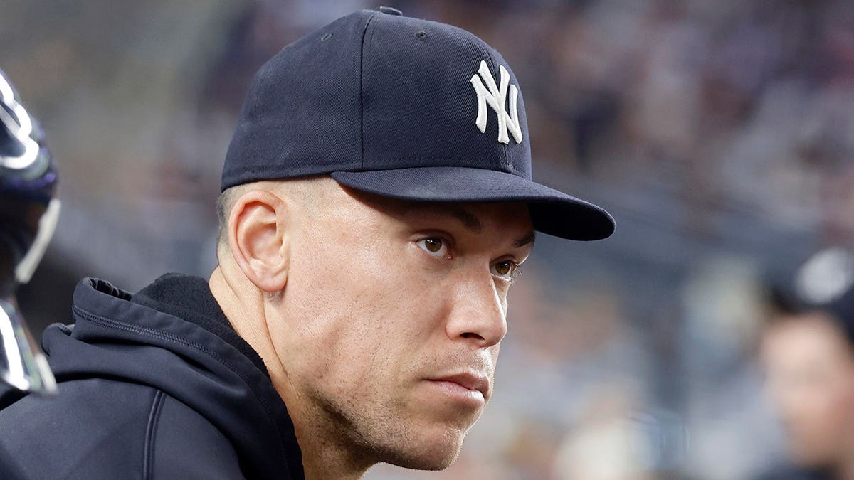 Aaron Judge of the New York Yankees looking on from the dugout at Yankee Stadium
