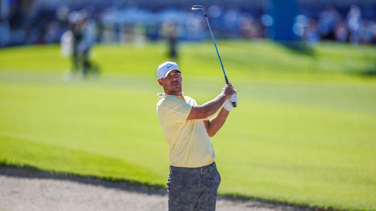 Brooks Koepka playing a shot from a bunker on the 18th hole at Torrey Pines Municipal Golf Course