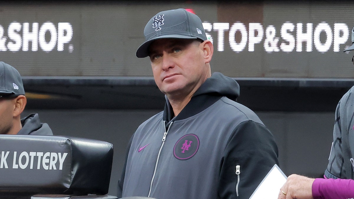 New York Mets manager Carlos Mendoza watching from the dugout at Citi Field.