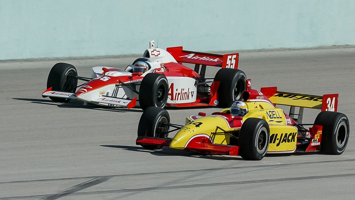 Laurent Redon driving the #34 Dallara Infiniti car next to Rick Treadway driving the #55 G Force Chevrolet car on a race track