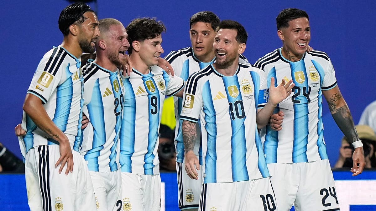 Argentina's Lionel Messi celebrating with teammates on the soccer field.