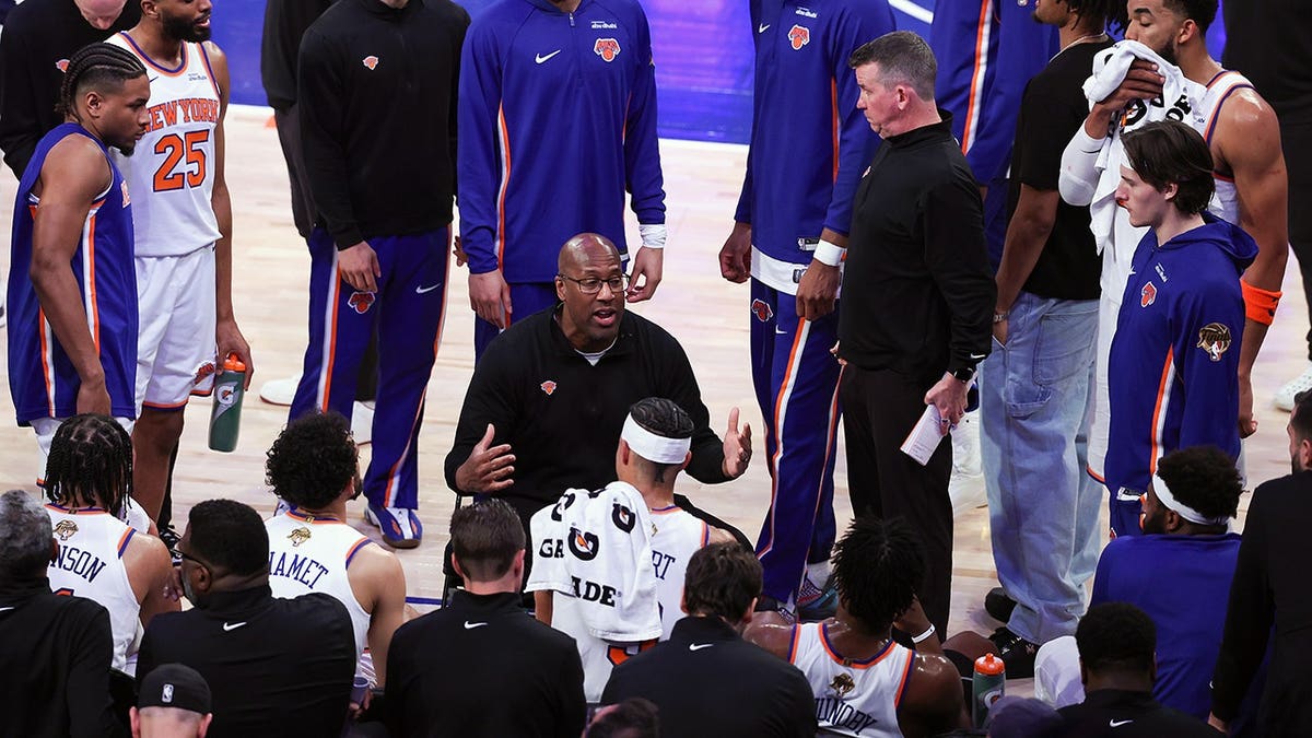 Mike Brown talking with New York Knicks players during a timeout at Madison Square Garden